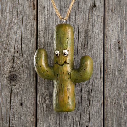 Bert Anderson Southwestern cactus ornament with smiling face and jute hanger displayed against rustic weathered barnwood.