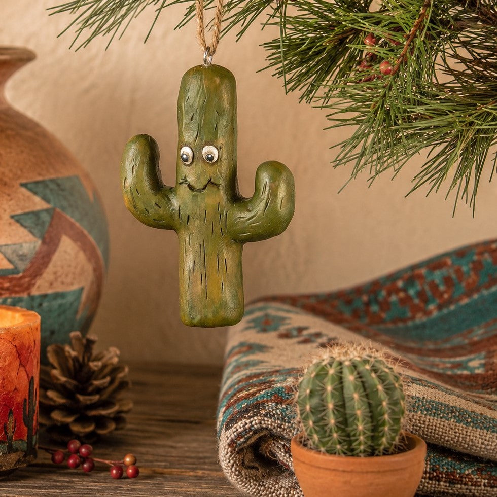 Bert Anderson cactus ornament hanging in a Southwestern décor setting with desert pottery, cactus accents and evergreen.