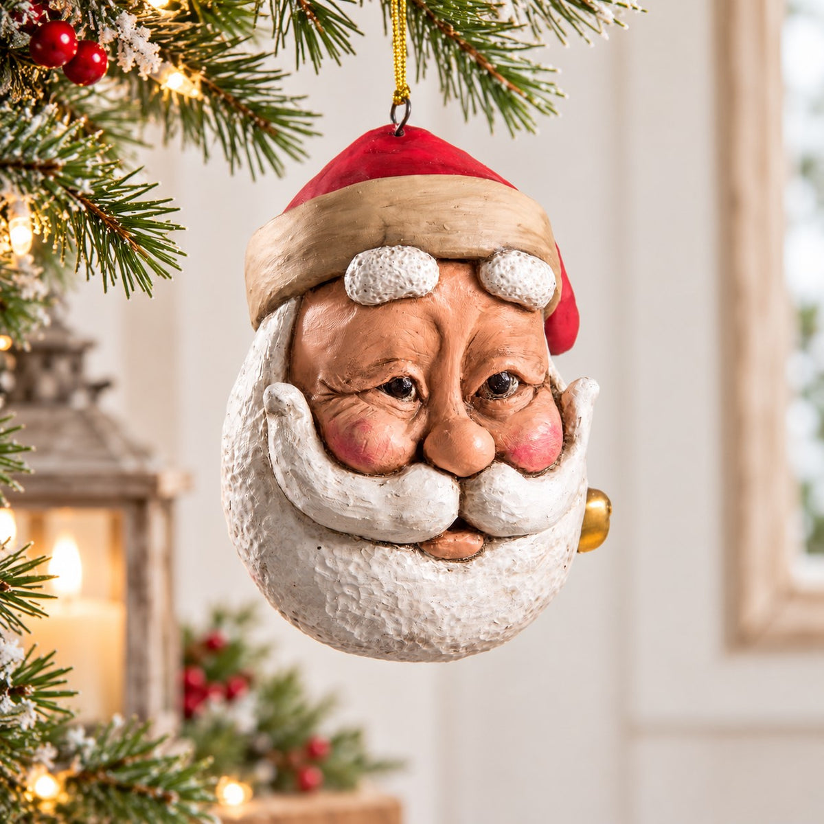 Bert Anderson Santa face ornament with red hat, rosy cheeks and white beard displayed against a light Christmas background with subtle holiday greenery