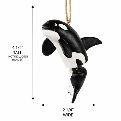 A black and white orca whale hanging ornament shown on a white background with dimension arrows indicating a height of 4 1/2 inches and a width of 2 1/4 inches, excluding the hanger.