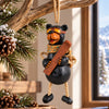 Bert Anderson skiing bear ornament with goggles and skis displayed in a bright mountain lodge with rustic wood accents and snowy mountain views.