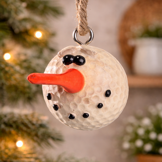 Golf ball snowman ornament hanging on a Christmas tree