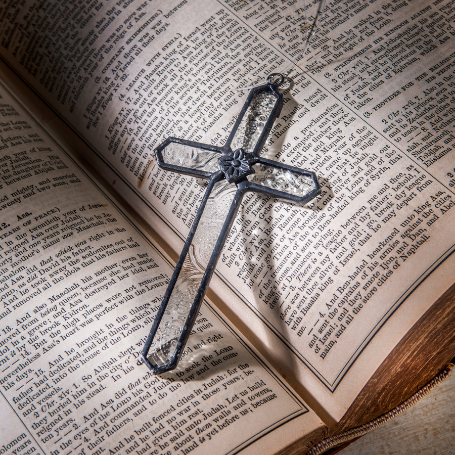 Small Victorian Glass Cross Suncatcher, cross displayed near books