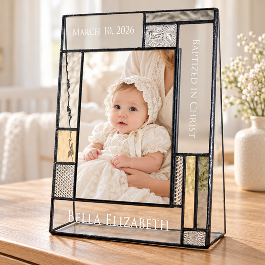 Personalized 4x6 vertical baptism frame with muted gray and amber glass, showing a baby in an ivory christening gown; engraved March 10, 2026, Baptized in Christ and Bella Elizabeth.