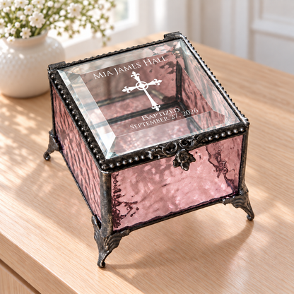 Pink textured glass baptism keepsake box with a clear transparent beveled lid engraved Mia James Hall, a cross, Baptized and September 27, 2026.
