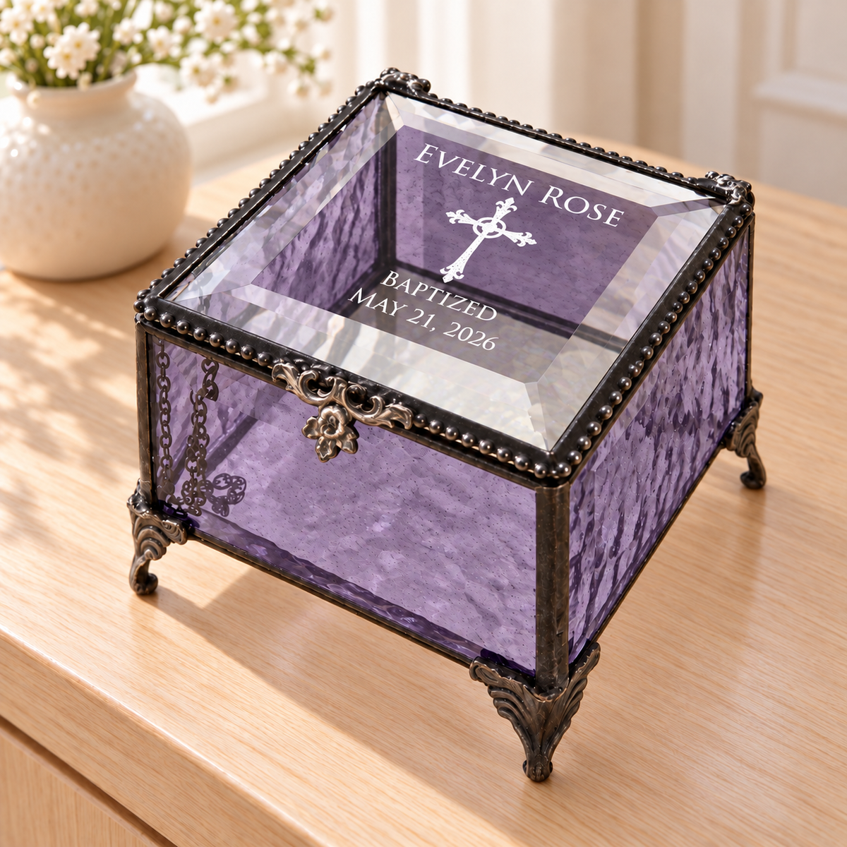 Purple textured glass baptism keepsake box engraved Evelyn Rose, a cross, Baptized and May 21, 2026, with a clear beveled lid and decorative feet.