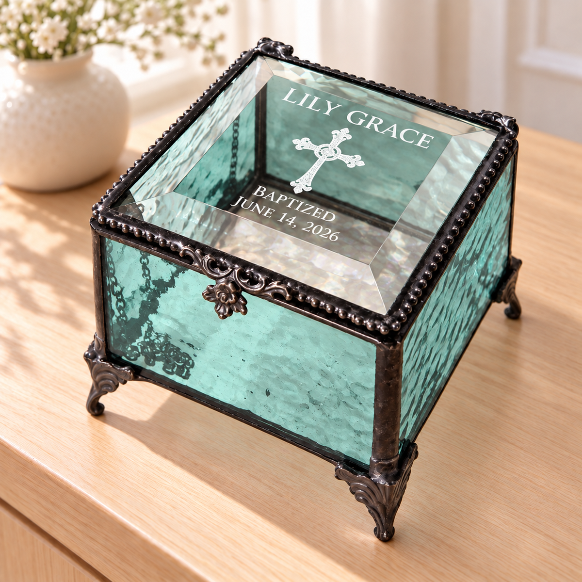 Turquoise textured glass baptism keepsake box engraved Lily Grace, an ornate cross, Baptized and June 14, 2026, with a clear beveled lid and decorative feet.