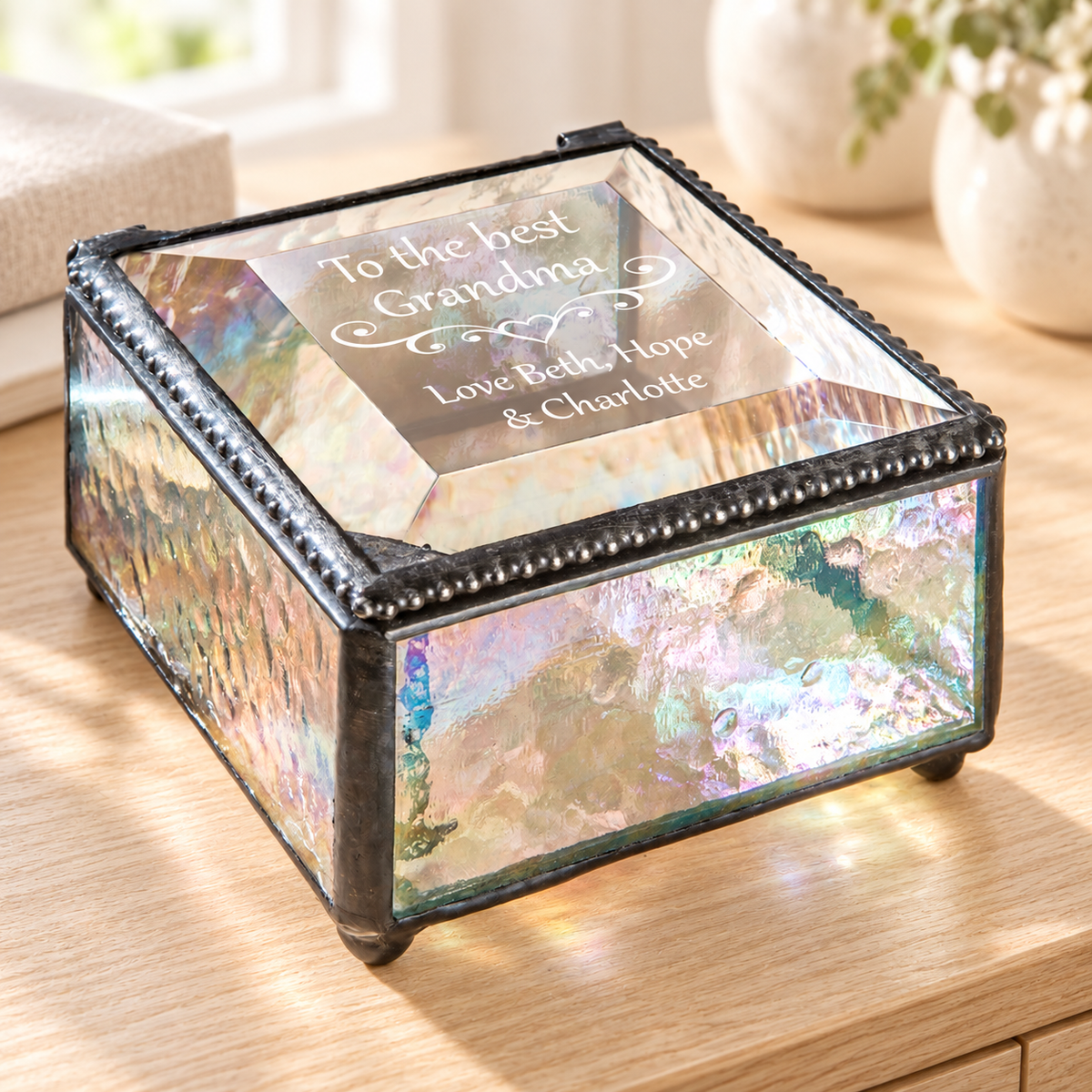 J Devlin clear iridescent glass Grandma keepsake box with a beveled lid, heart scrollwork, and “To the best Grandma, Love Beth, Hope & Charlotte” engraving.