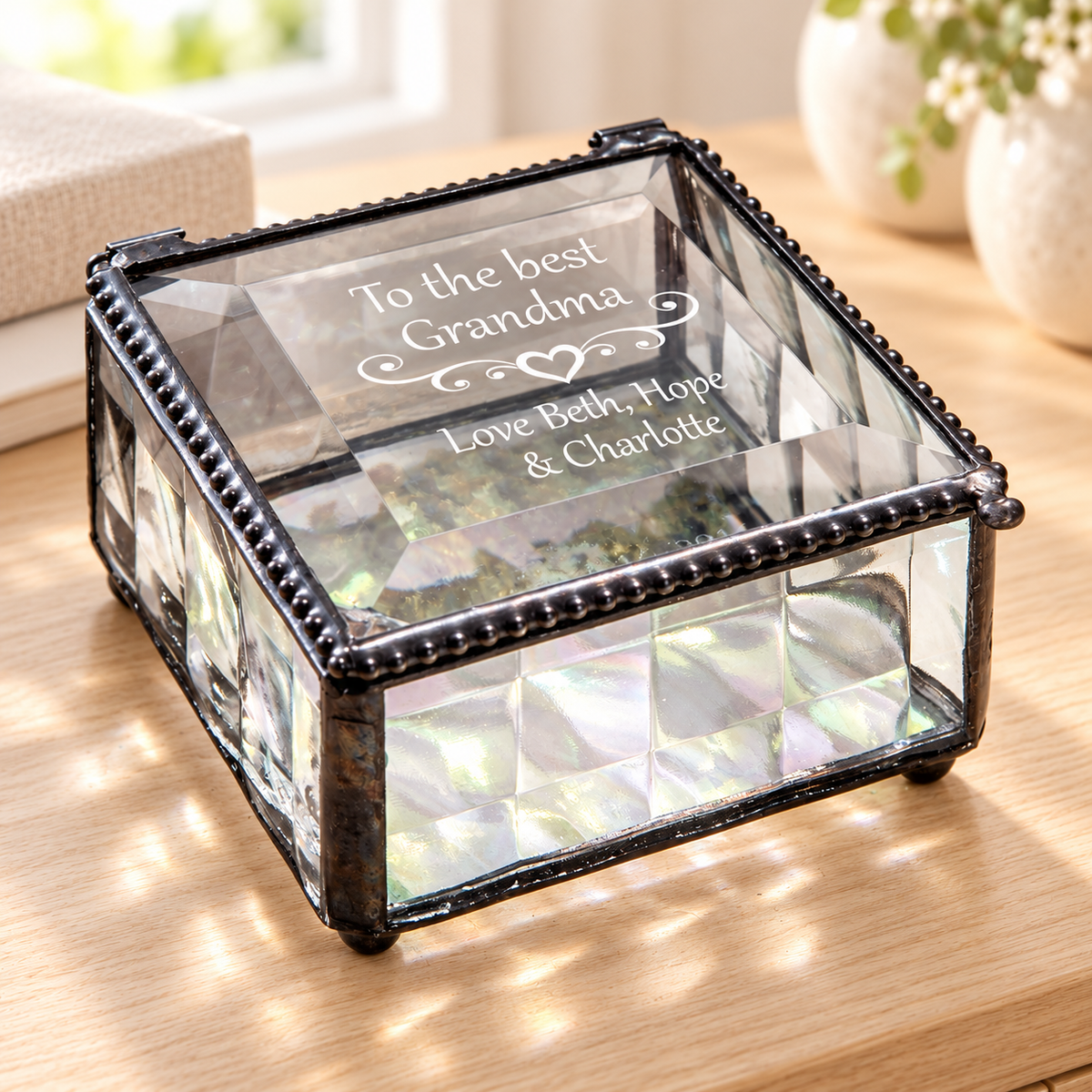 J Devlin clear cubed glass Grandma keepsake box with a clear beveled lid, heart scrollwork, and “To the best Grandma, Love Beth, Hope & Charlotte” engraving.