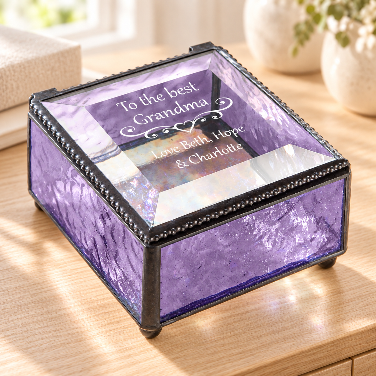 J Devlin purple glass Grandma keepsake box with a clear beveled lid, heart scrollwork, and “To the best Grandma, Love Beth, Hope & Charlotte” engraving.
