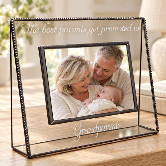 J Devlin 4 × 6 horizontal clear glass frame engraved “The best parents get promoted to Grandparents,” displaying grandparents cuddling a baby.