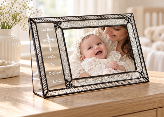 Personalized clear vintage glass baptism frame with a mother holding her baby in an ivory christening gown; engraved God Bless, Elizabeth Ann, Baptized and 04.09.26.